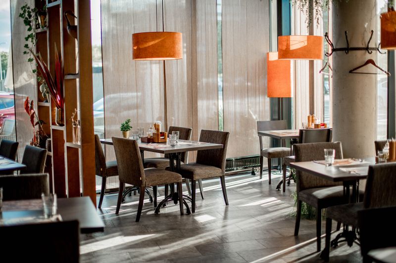 Round table pizza restaurant interior — warm, inviting dining space